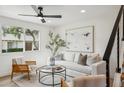 Stylish living room featuring a modern sofa, neutral colors, and a large window at 4323 N Miller Rd, Scottsdale, AZ 85251