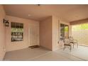 Cozy covered back patio features outdoor seating and a secure screen door for relaxed outdoor living at 4433 W Phalen Dr, Phoenix, AZ 85087
