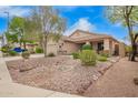 Inviting single-story home featuring desert landscaping, rock features, and a covered porch at 4433 W Phalen Dr, Phoenix, AZ 85087