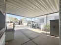 Covered carport with ample parking space and views of neighboring manufactured homes in a quiet community at 457 S Jaspar Dr, Apache Junction, AZ 85119