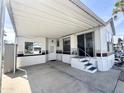 Exterior view of a manufactured home with a covered carport and easy access sliding glass door at 457 S Jaspar Dr, Apache Junction, AZ 85119