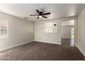 Spacious living room with neutral walls and carpeted flooring, and a ceiling fan at 4659 E Pinto Valley Rd, San Tan Valley, AZ 85143