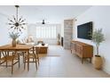 Bright living room featuring a modern light fixture, fan, fireplace and contemporary furnishings at 4803 N Woodmere Fairway -- # 1003, Scottsdale, AZ 85251