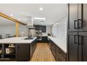 Modern kitchen boasts dark cabinetry, stainless steel appliances, a skylight, and a stylish backsplash at 4907 E Piccadilly Rd, Phoenix, AZ 85018