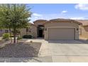 Charming single-story home featuring a two-car garage, desert landscaping, and a beautiful red tile roof at 4932 S Verbena Ave, Gilbert, AZ 85298