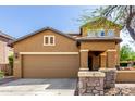 Charming two-story home featuring a two-car garage, inviting front porch, and low maintenance desert landscaping at 7359 W Kings Ave, Peoria, AZ 85382