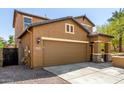 Charming two-story home featuring a two-car garage, inviting front porch, and low maintenance desert landscaping at 7359 W Kings Ave, Peoria, AZ 85382