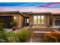 Inviting home featuring desert landscaping and a cozy front porch at 77 E Atole Ct, Queen Creek, AZ 85140