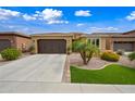 Charming single-story home featuring a well-manicured yard, a two-car garage and neutral color palette at 77 E Atole Ct, Queen Creek, AZ 85140