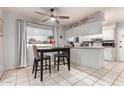 Bright dining area with tile flooring, a modern table, and easy access to the kitchen at 810 W Villa Maria Dr, Phoenix, AZ 85023
