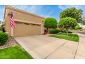 View of the home's front exterior with a spacious driveway and well-maintained landscaping and garage at 9442 N 106Th Pl, Scottsdale, AZ 85258