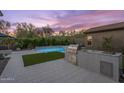 Backyard featuring a built in grill and pristine pool perfect for relaxation and outdoor entertainment at 10778 N 137Th St, Scottsdale, AZ 85259