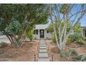 Charming home with stepping stone pathway, desert landscaping, and white exterior at 1345 W 14Th St, Tempe, AZ 85281