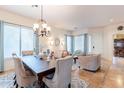 Formal dining area boasts a chandelier, six chairs, and a seamless flow into the living spaces at 1919 S Granite St, Gilbert, AZ 85295