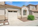 Charming exterior showcasing a one-car garage and neutral stucco at 2600 E Springfield Pl # 58, Chandler, AZ 85286