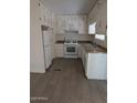 Charming kitchen offering white cabinets, modern appliances, and functional layout at 2630 E Beverly Ln, Phoenix, AZ 85032