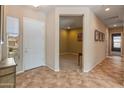 Bright foyer featuring tiled floors, white door, and views of the adjacent room at 26473 W Runion Ln, Buckeye, AZ 85396