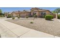 View of the front yard featuring desert landscaping for water conservation and curb appeal at 28942 N Lazurite Way, San Tan Valley, AZ 85143