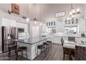 Bright, modern kitchen with white cabinetry, granite countertops, and a center island with seating at 29756 N Varnum Rd, San Tan Valley, AZ 85143