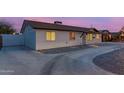 Well-lit single-story home boasting a spacious driveway and low maintenance desert landscaping at 3209 E Marilyn Rd, Phoenix, AZ 85032