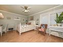 Comfortable bedroom featuring natural light, a ceiling fan, and a cozy armchair at 3328 S Stanley Pl, Tempe, AZ 85282