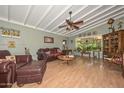 Cozy living room with hardwood floors, a ceiling fan, and ample natural light at 3328 S Stanley Pl, Tempe, AZ 85282