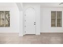 Bright entryway with tile flooring, white walls, and a classic white front door framed by windows at 3591 S Ranger Trl, Gilbert, AZ 85297