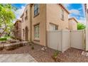 Side view of a two-story home showcasing beige stucco, decorative balcony, and tidy landscaping at 3591 S Ranger Trl, Gilbert, AZ 85297