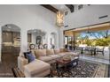 Open living room boasts vaulted ceilings, exposed beams, and a seamless transition to outdoor dining at 3980 E Sierra Vista Dr, Paradise Valley, AZ 85253