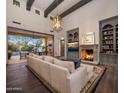 Inviting living room features fireplace, custom built-ins, and large sliding doors to the backyard at 3980 E Sierra Vista Dr, Paradise Valley, AZ 85253