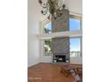 Bright living room features a grand fireplace, high ceilings, and a statement chandelier at 4020 E Laurel Ln, Phoenix, AZ 85028