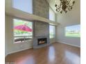 Bright living room with a cozy fireplace, hardwood floors, and ample natural light at 4020 E Laurel Ln, Phoenix, AZ 85028