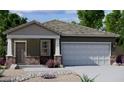 Charming single-story home featuring a two-car garage, neutral tones, and drought-resistant landscaping at 4128 E Kolin Ln, San Tan Valley, AZ 85143