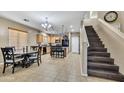 Charming kitchen and dining area featuring a breakfast bar, and modern appliances at 41369 W Parkhill Dr, Maricopa, AZ 85138