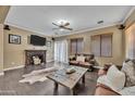 Inviting living room featuring a fireplace, hardwood floors and neutral tones at 41369 W Parkhill Dr, Maricopa, AZ 85138