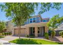 Charming two-story home with a well-manicured lawn, a two-car garage, and a brick-accented front porch at 4253 E Palo Verde St, Gilbert, AZ 85296