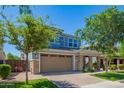 Charming two-story home with a brick facade, a two-car garage, and lush landscaping at 4253 E Palo Verde St, Gilbert, AZ 85296