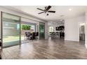 Spacious living room with tile floors, ceiling fan, and sliding glass doors leading to the outdoor patio at 4253 E Palo Verde St, Gilbert, AZ 85296