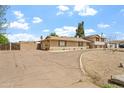 Spacious home with an extended driveway, basketball hoop, brick accents, and lush landscaping at 4332 W Monte Cristo W Ave, Glendale, AZ 85306