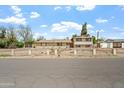 Attractive home showcasing a well-maintained yard, distinctive brick accents, and a decorative fence at 4332 W Monte Cristo W Ave, Glendale, AZ 85306
