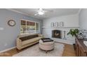 Bright living room with a brick fireplace, modern furnishings, and large window at 4440 E Campbell Ave, Phoenix, AZ 85018