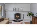 Charming living room showcasing a white brick fireplace with decorative mantle and art at 4440 E Campbell Ave, Phoenix, AZ 85018