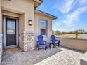 Cozy front porch featuring Adirondack chairs, a small table, and a charming desert view at 5581 N 206Th Ave, Buckeye, AZ 85396