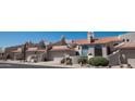 View of multiple attached townhomes with desert landscaping, tile roofs, and garages at 6144 S Fairway Pl, Gold Canyon, AZ 85118