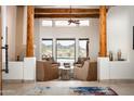 Inviting living room featuring wood beams, neutral furnishings, and scenic desert views at 8400 E Dixileta Dr # 153, Scottsdale, AZ 85266