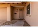 Inviting front entrance featuring a decorative door, stylish hardware, and a welcoming mat at 8637 E Weldon Ave, Scottsdale, AZ 85251