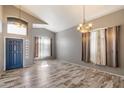 Spacious living room with high ceilings, hardwood floors, and ample natural light at 8708 S 50Th Ln, Laveen, AZ 85339