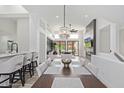 Open-concept dining area with modern chandelier, connecting to a spacious living room at 8989 N Gainey Center Dr # 231, Scottsdale, AZ 85258