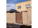 Charming home featuring a private entrance gate and stucco exterior with a gazebo visible over the fence at 948 S Alma School Rd # 115, Mesa, AZ 85210