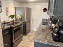 Well-equipped kitchen with stainless steel appliances and gray cabinetry providing plenty of space at 948 S Alma School Rd # 115, Mesa, AZ 85210